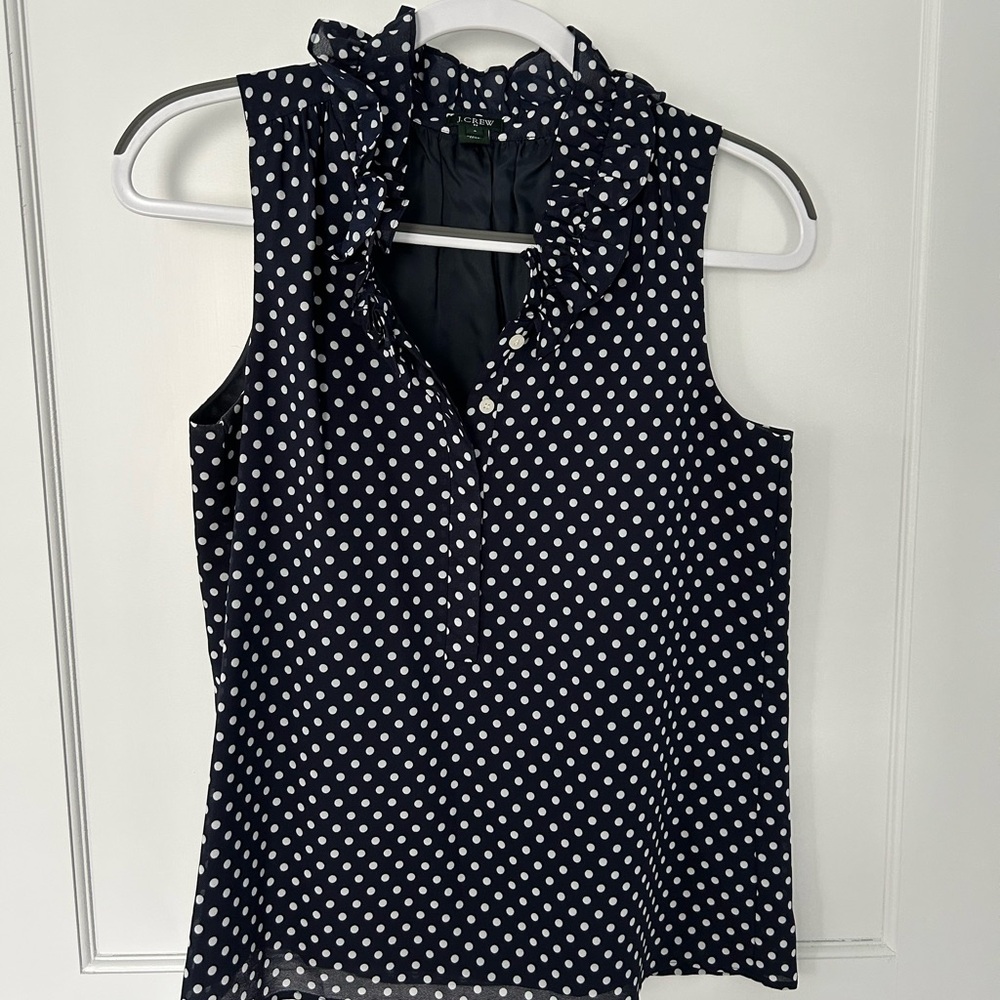 Navy sleeveless top with white polka dots, size 4
